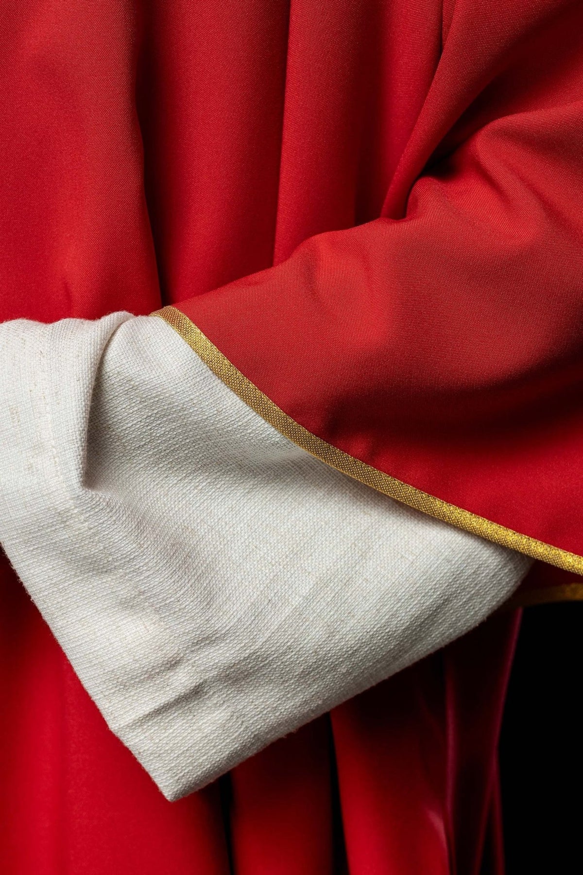 Rote Dalmatik, Detail des glatten Stoffes und der goldenen Ärmelborte