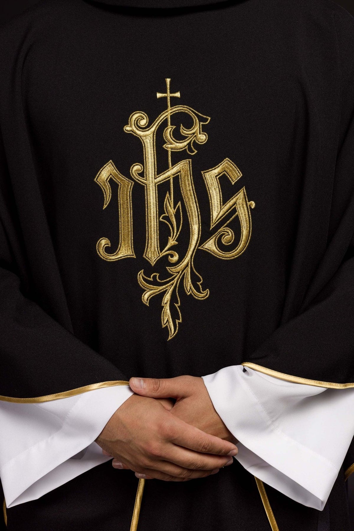 Messgewand mit Nahaufnahme der goldenen IHS-Stickerei auf der Vorderseite