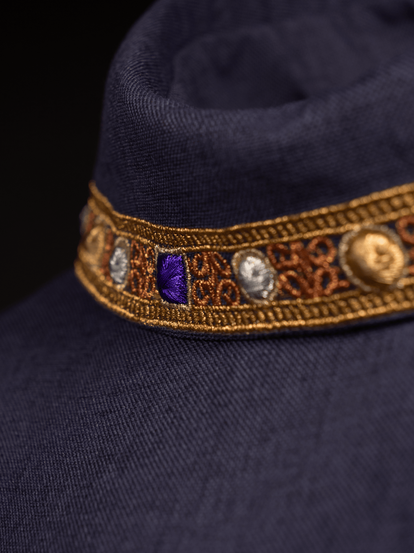 Ornat w kolorze fioletowym z haftowaną lamówką na kołnierzu i wokół haftu krzyża